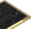 A close-up view of a black marble table with a gold frame. Podgląd zdjęcia produktu