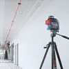 A construction worker uses a laser level to mark a ceiling in a hallway. Anteprima dell’immagine prodotto