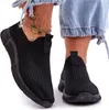 Close-up of a person's feet wearing black slip-on sneakers. Náhľad obrázku produktu