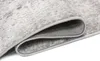 A close-up view of a folded rug, showing the texture and edge binding. Anteprima dell’immagine prodotto