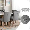 A dining room scene with gray velvet chairs around a table, highlighting the ring detail on the back of the chairs. Náhľad obrázku produktu