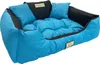 A blue dog bed with black accents and two small pillows. Náhled obrázku produktu