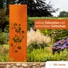 A rusted metal garden screen with a rose and flower design, placed in a garden setting with various plants and flowers. Produktbild-Vorschau