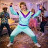 A group of people at a party, with confetti on the floor. Produktbild-Vorschau