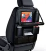A black car seat organizer with multiple compartments, a tablet holder, and a tray, attached to the back of a car seat. Anteprima dell’immagine prodotto