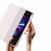 Hands holding a pink tablet case with a tablet inside, showing how to insert or remove the tablet. Produktbild-Vorschau