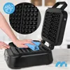 A hand is cleaning a black waffle maker with a blue cloth. A circular inset shows a close-up of the waffle iron plates. Náhľad obrázku produktu