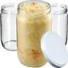 Three glass jars, one filled with sauerkraut, and a white lid. Podgląd zdjęcia produktu