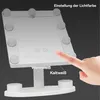 A hand is touching a makeup mirror with LED lights, demonstrating its features. Produktbild-Vorschau