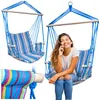 A woman is sitting in a striped hammock chair and talking on her phone. Anteprima dell’immagine prodotto