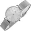 A close-up, angled view of a Daniel Wellington watch with a silver mesh band and a silver dial. Produktbild-Vorschau