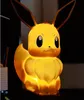 A glowing Eevee lamp sits on a dark surface. Náhľad obrázku produktu