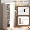 A tall white cabinet with its doors open, revealing shelves with various items. Inset images show details of an anti-toppling device. Náhled obrázku produktu