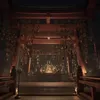 A dimly lit interior of a Japanese shrine or temple, with a large red torii gate adorned with many small bells in the foreground. In the background, a golden statue or altar is visible, surrounded by more decorative elements and candles. Náhled obrázku produktu