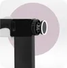 Close-up of a black safety gate mechanism with a circular white light. Voir les images du produit