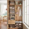 A hallway or entryway with a wooden wardrobe unit, featuring shelves for shoes, a bench, and hooks for coats and hats. Voir les images du produit