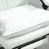 A close-up view of a white office chair cushion and a pillow on top of it. Produktbild-Vorschau