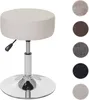 A cream-colored round stool with a silver adjustable base and lever. Náhľad obrázku produktu