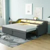 A bedroom or living room setting with a sofa bed extended into a bed, featuring integrated lighting and storage. Produktbild-Vorschau
