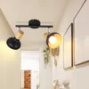 A hallway with a ceiling light fixture and artwork on the wall. Voir les images du produit