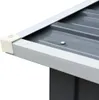 A close-up view of the corner of a gray metal structure, possibly a shed or storage unit, showing a white corner protector and a ribbed metal roof. Náhľad obrázku produktu