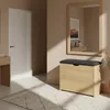 A hallway with a white door, a console table, a shoe cabinet with a seat, and a mirror. Náhľad obrázku produktu