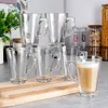 A collection of clear glass mugs with handles, some filled with a coffee-like beverage, arranged on a wooden board and countertop. Podgląd zdjęcia produktu