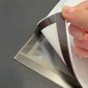 A hand is peeling back a magnetic frame from a diamond painting. Podgląd zdjęcia produktu