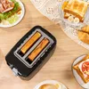 A breakfast scene with a toaster, toast, salad, and croissants on a wooden table. Produktbild-Vorschau