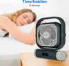 A woman sleeping in bed with a portable fan on a nightstand. Produktbild-Vorschau
