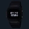 A close-up, front-facing shot of a black digital watch with its screen illuminated. Produktbild-Vorschau