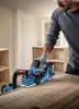 A person is using a Bosch power tool on a wooden surface. Produktbild-Vorschau