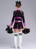A young person wearing a cheerleading costume, holding pom-poms. Produktbild-Vorschau