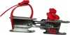 A pair of red children's ice skates with metal blades and red straps, shown against a white background. Voir les images du produit