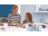 A woman and a child are wrapping gifts together at a table. Náhled obrázku produktu