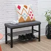 A shoe bench with a cushion and a decorative pillow, placed in a room with a brick wall and a rug. Podgląd zdjęcia produktu