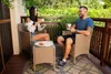 A couple enjoying coffee and macarons on a balcony. Produktbild-Vorschau