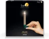 A hand holding a decorative Christmas candle with a clip attachment, presented on a black background with product branding. Produktbild-Vorschau