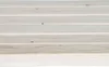 A close-up view of wooden planks with a light finish. Voir les images du produit