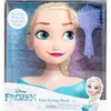 The image shows a Disney Princess Elsa Styling Head toy in its packaging. The packaging features a large image of Elsa's face and hair, along with the Disney Frozen logo and product title. A smaller image of Elsa is also present on the bottom right of the  Voir les images du produit