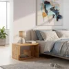 A bedroom scene with a nightstand next to a bed. Produktbild-Vorschau