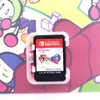 A Nintendo Switch game cartridge in its case, placed on a colorful background with cartoon characters. Produktbild-Vorschau