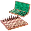 A wooden chess set with pieces on the board and pieces stored in the open box. Podgląd zdjęcia produktu