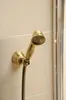 A close-up shot of a vintage-style bronze hand shower head mounted on a tiled wall. Náhled obrázku produktu