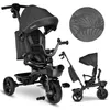 A black Lionelo Kori tricycle with a canopy and parent push bar is shown, along with a circular swatch of the fabric pattern. A smaller, scaled-down version of the tricycle is also visible. Produktbild-Vorschau