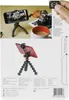A product shot showing a flexible tripod holding a smartphone, with a camera and a cup of coffee in the background. The bottom part of the image shows a close-up of a red smartphone on a similar tripod. Náhled obrázku produktu