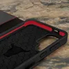 Close-up view of the interior of a black phone case with red trim and a hexagonal pattern. A silhouette of a bull's head is visible on the interior surface. Anteprima dell’immagine prodotto