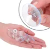A hand holding several transparent suction cups with metal screws. Produktbild-Vorschau