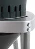 A close-up view of the top part of a grain mill, focusing on the connection between the motor housing and the support legs. Náhled obrázku produktu