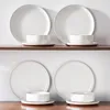 A set of white ceramic plates and bowls with brown rims, arranged on two shelves. Produktbild-Vorschau